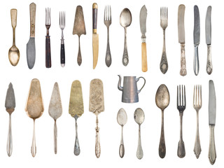 Vintage Silverware, antique spoons, forks, knives, ladle, cake shovels, kettle, tray and ice bucket isolated on isolated white background. Antique silverware. Retro.