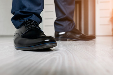 Fototapeta na wymiar men feet in black shoes close-up