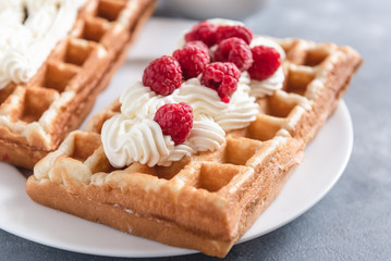 Homemade waffles with raspberries and cream