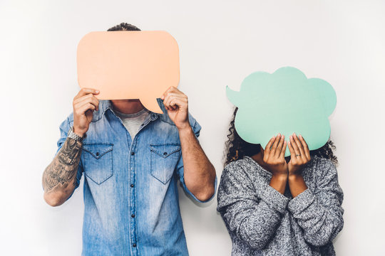 Two friends holding a speech bubble icon together