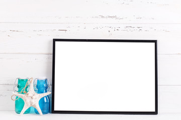 Empty  black frame mockup  with copy space and ocean vacation  decorations