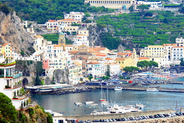 Panoramic scenic view of Amalfi Coast, Campania, Italy, in summer with traditional Italian architecture on mountains, beautiful blue sea and luxury yachts