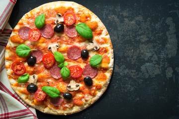 Italian pizza with salami and fungi