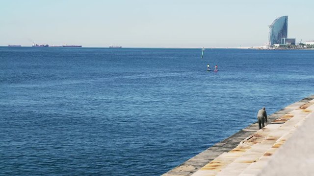 Sportsman rower on a kayak. Sunny day. People do sports. People ride on boats. People rowing oars standing on the boat. Sportsman rower on boat. Extreme sport. 