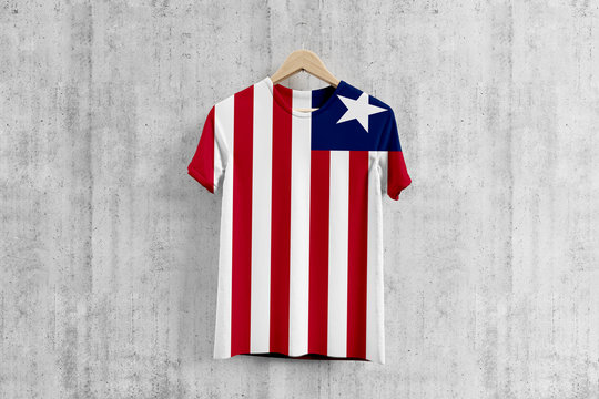 Liberia flag T-shirt on hanger, Liberian team uniform design idea for garment production. National wear.