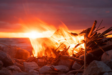 fire burns near the sea