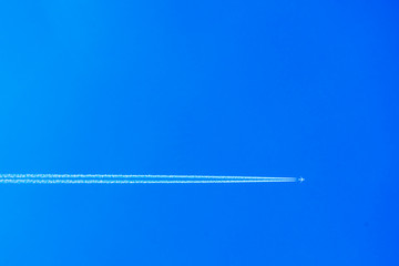 ..Airplane with contrail in the blue sky. The concept of freedom, moving forward. Sky background. Forward to 2020.