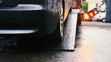 emergency vehicle in the rainy flashing headlights signals. tow truck.