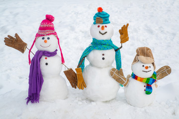 Christmas background with snowman family. Happy winter time. Snowman isolated on snow background. Snow men. Winter time scene. New year concept.
