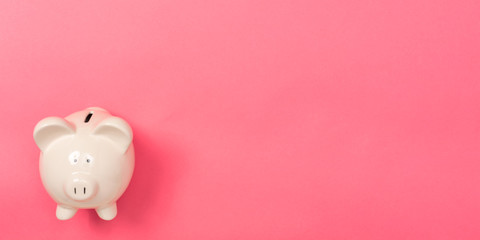 A piggy bank saving and investment theme on a pink paper background