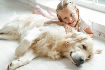 A child with a dog at home. 