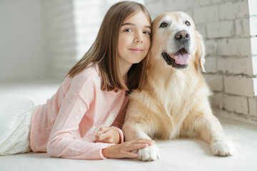 Child with a dog. A girl with labradors at home.