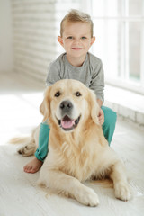 Child with a dog at home 