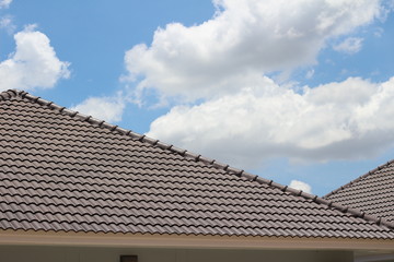 tiles roof on new house with blue sky