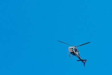Fototapeta na wymiar elicopter overhead in blue sky