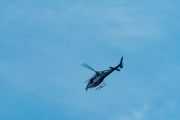 elicopter overhead in blue sky