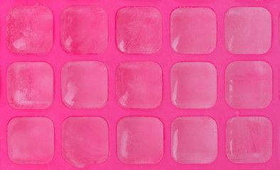 Ice cubes in pink ice tray
