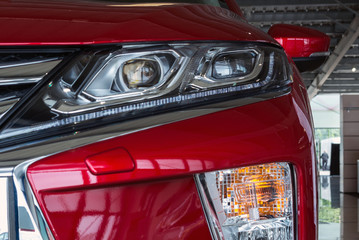 Ukraine, Cherkasy, May 2019. Headlight of a modern  red car. Close-up. Detail of automotive...