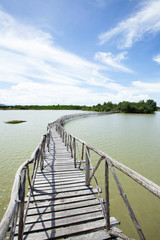 Empty wooden footbridge on a lake.