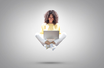 Happy beautiful woman with laptop hovering in the air