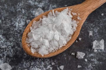 Fototapeta na wymiar Sea Salt Flakes Spilled from a Teaspoon