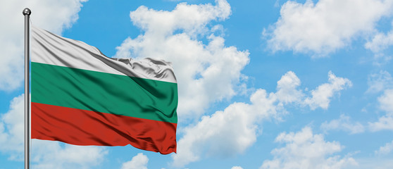 Bulgaria flag waving in the wind against white cloudy blue sky. Diplomacy concept, international relations.