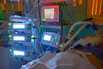 Glowing monitors in intensive care department. Nigth shift at icu, patient in critical state.