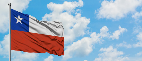 Chile flag waving in the wind against white cloudy blue sky. Diplomacy concept, international relations.