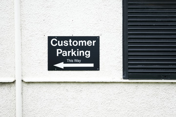 Customer parking direction arrow sign