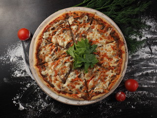 Pizza with mozzarella, tomatoes and meat