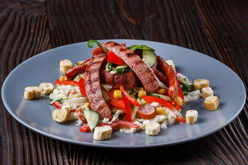 Salad with grilled sausage paprica cucumber and croutons
