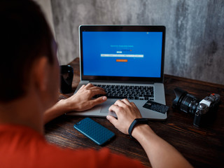 A man buys tickets for a trip online for a computer. Online opalat with credit cards. booking air tickets online