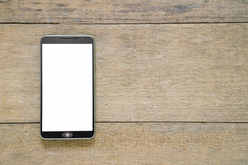 Smartphone with white screen on vintage grunge wooden background