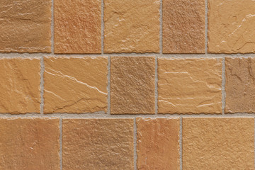 Brown stone block tile wall texture and seamless background
