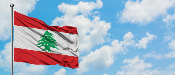 Lebanon flag waving in the wind against white cloudy blue sky. Diplomacy concept, international relations.