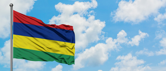 Mauritius flag waving in the wind against white cloudy blue sky. Diplomacy concept, international relations.