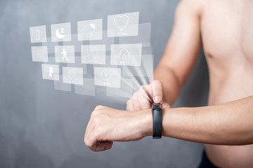 A Sport man is using smart band with virtual screen device