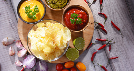 Composition with bowl of potato chips.