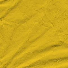 Transparent yellow plastic wrap on the black background. Plastic shopping bag texture. Reusable trash and waste.