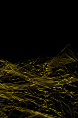 Transparent yellow plastic wrap on the black background. Plastic shopping bag texture. Reusable trash and waste.