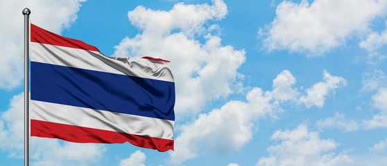 Thailand flag waving in the wind against white cloudy blue sky. Diplomacy concept, international relations.
