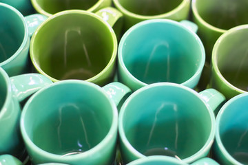 Many colorful empty ceramic cups in store, Mugs background