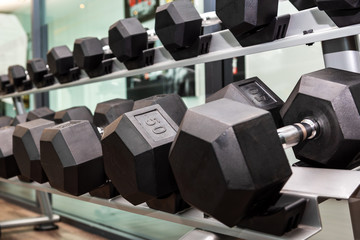 A lot of many dumbbells in sports club or fitness gym for weight training equipment  and exercises