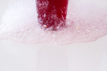 soap bubbles on a glass on white background