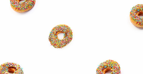 donuts in colorful sprinkles on white background. Donut with sprinkles isolated on white background top view. Delicious Donut. copy space, banner