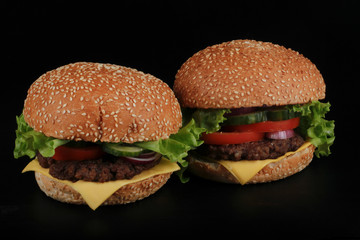 two hamburger on black background