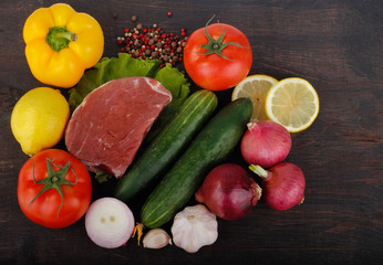 beef with vegetables on wooden background. top view