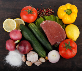 beef with vegetables on wooden background. top view