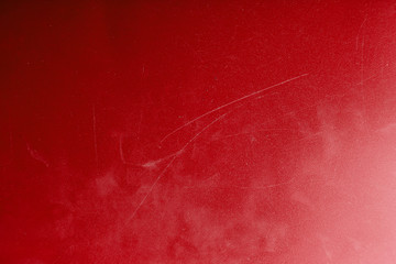 Bright abstract dirty red texture with scratches and scuffs