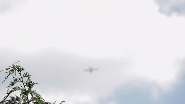 Rack Focus Single Engine Private 
Aircraft Flying Through Cloudy Sky.